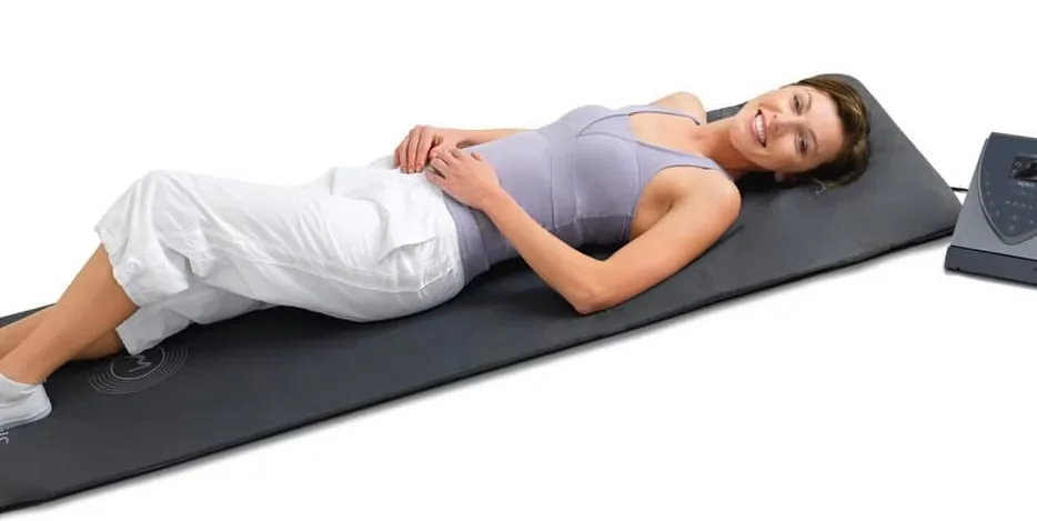 A client lying on the BEMER PEMF therapy mat