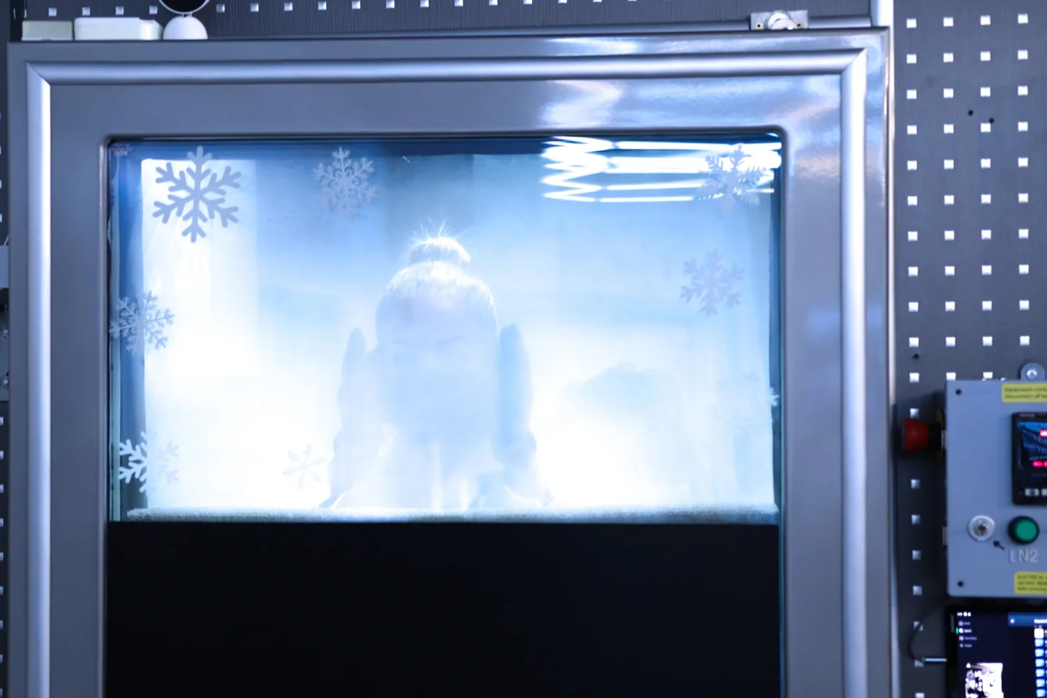 Frost and condensation across the cryochamber window during a session