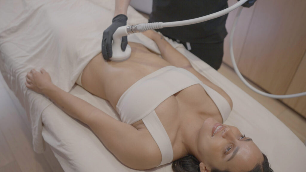 Woman on table getting t-shape treatment